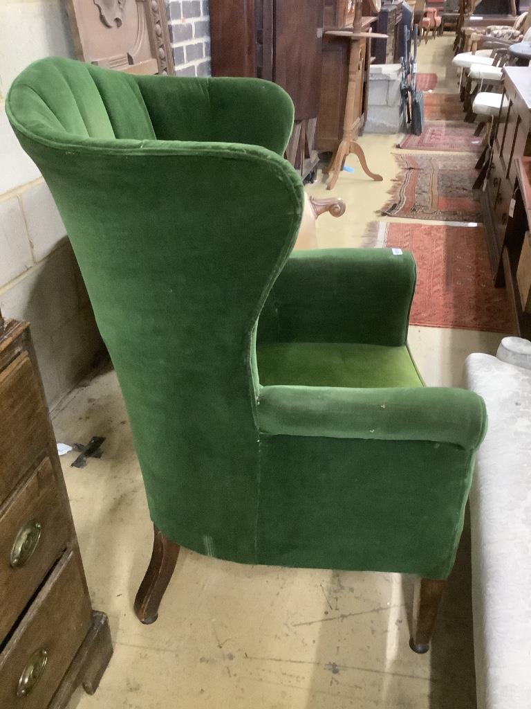 A George III mahogany wing armchair, on squared tapered legs, width 75cm
